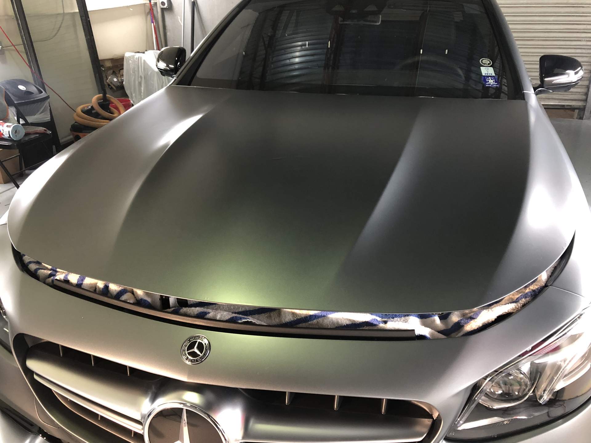 Grey Mercedes uncovered with fresh paint